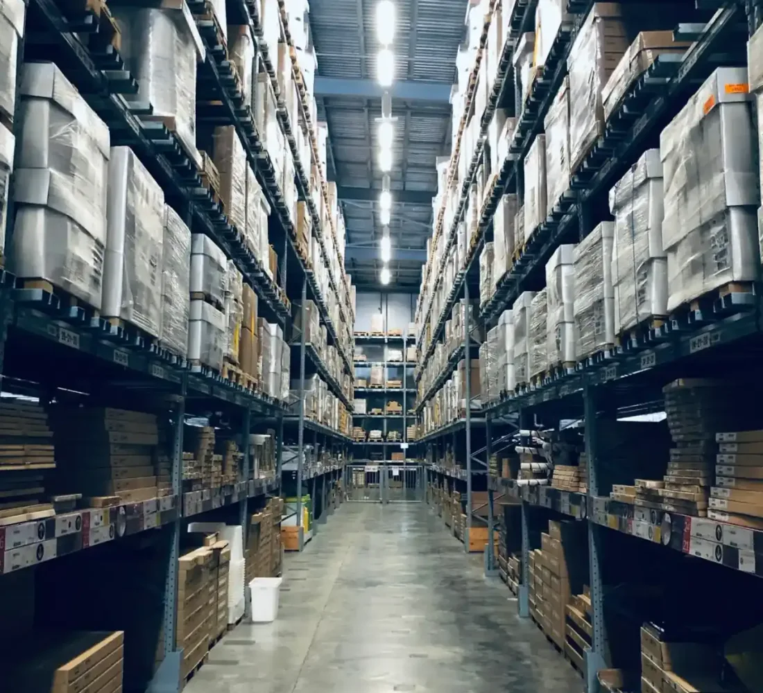 A warehouse aisle lined with stock, the everyday operating environment behind OpsUI